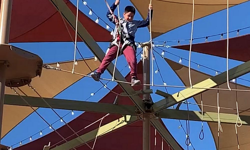 A boy balancing on ropes.